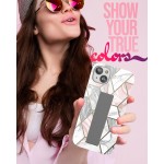 Positive attractive young brunette female person wearing stylish pink shirt grey hat and colourful sunglasses isolated over pink background holding in hand and showing mobile phone with empty display for mockup looking up